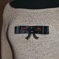 Selects pins with velvet ribbon, lace and Swarovsky.